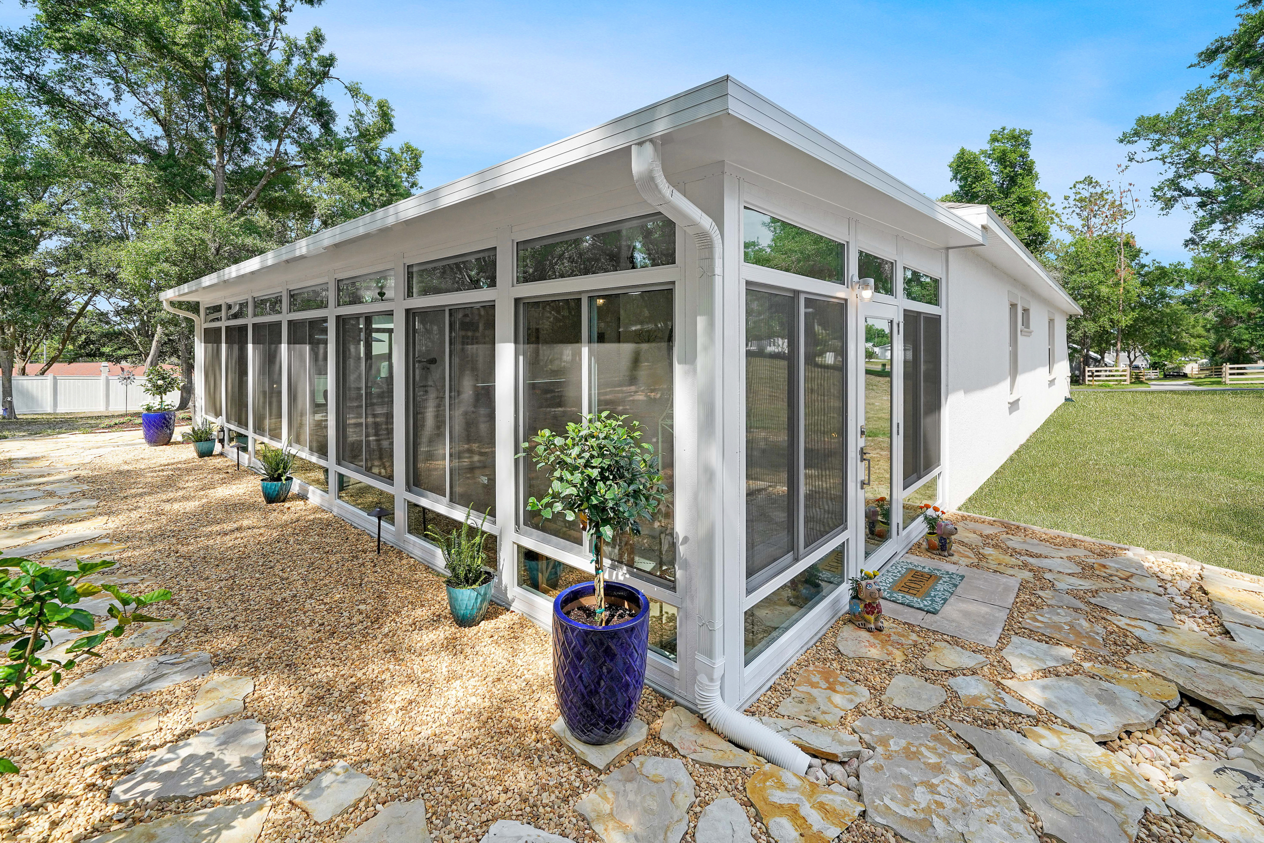 sleek studio sunroom with large windows, contemporary style roof, abundant sunlight, fresh air, functional outdoor space extension