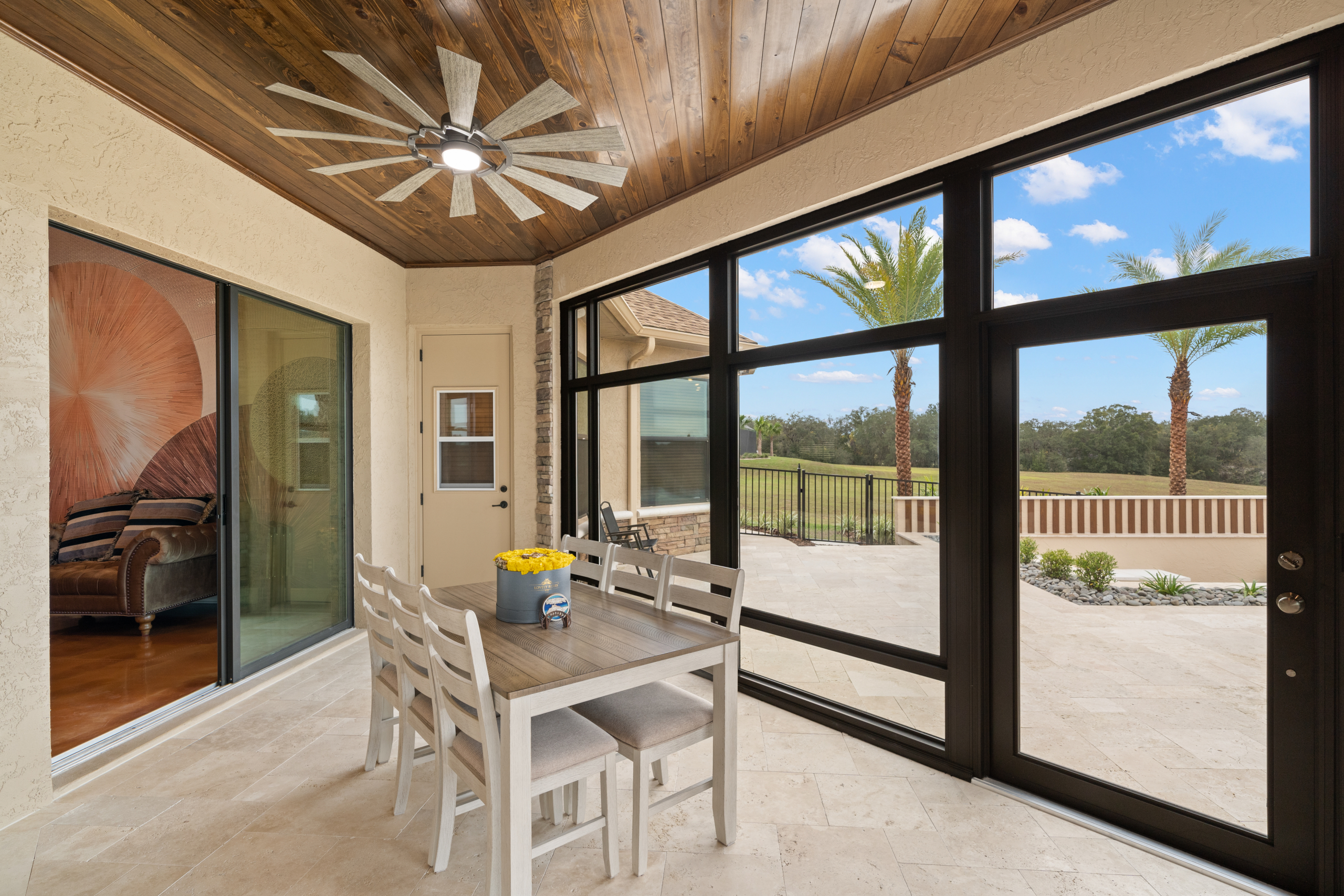 versatile sunroom addition with desk, couch, bookshelf, functional enclosed space for work, play, relaxation, bright natural light